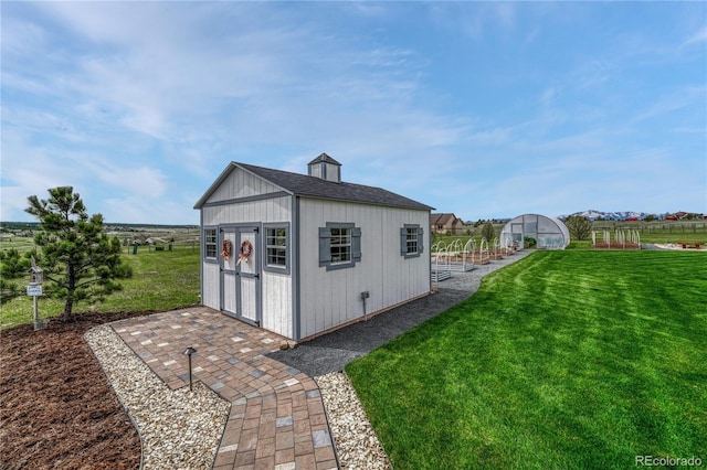 16256 Ridge Run Dr, Colorado Springs, CO 80908 - view of greenhouse featuring a lawn and a storage shed