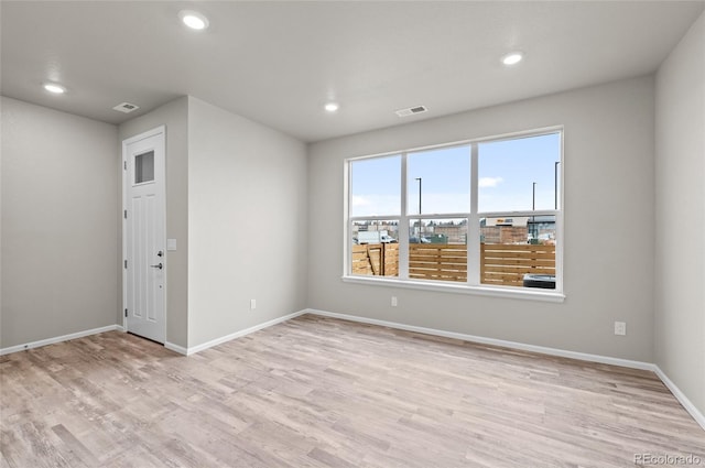 spare room with visible vents, recessed lighting, wood finished floors, and baseboards