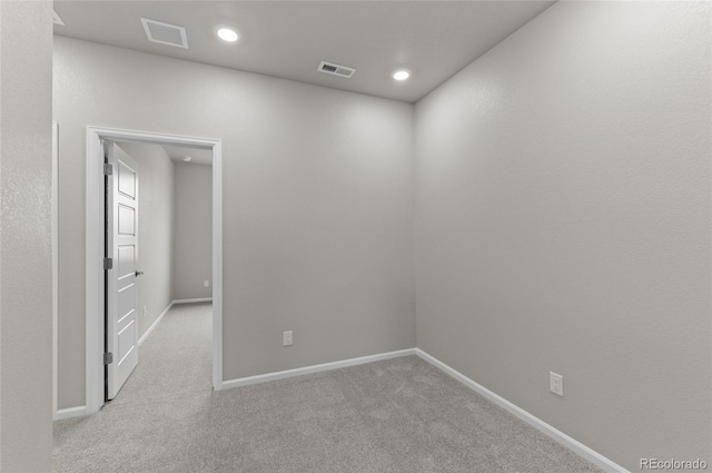 spare room featuring carpet flooring, recessed lighting, visible vents, and baseboards