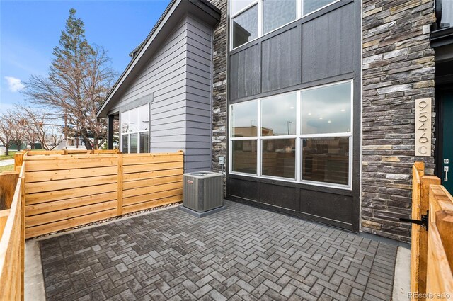 view of patio / terrace featuring central AC and fence