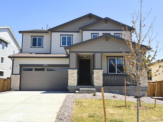 9082 Telluride Ct, Commerce City, CO 80022 - craftsman house featuring a porch, fence, stone siding, concrete driveway, and a garage