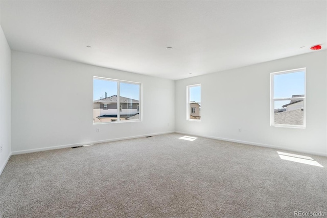 9082 Telluride Ct, Commerce City, CO 80022 - unfurnished room featuring baseboards, visible vents, and carpet