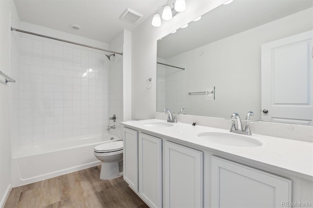 9082 Telluride Ct, Commerce City, CO 80022 - full bath with a sink, double vanity, toilet, and wood finished floors