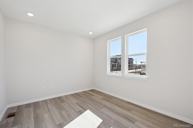 empty room with light hardwood / wood-style floors