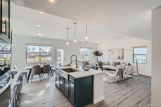 15336 W 68th Loop, Arvada, CO 80007 - kitchen featuring appliances with stainless steel finishes, light wood-style floors, light countertops, healthy amount of natural light, and recessed lighting