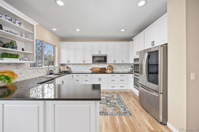 4467 Trailside Ln, Castle Rock, CO 80109 - kitchen featuring appliances with stainless steel finishes, a peninsula, open shelves, a sink, and decorative backsplash