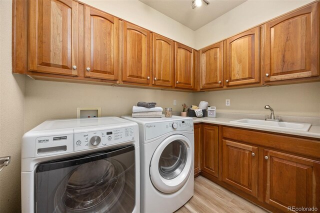 4467 Trailside Ln, Castle Rock, CO 80109 - laundry area featuring cabinet space, washer and clothes dryer, and light wood finished floors