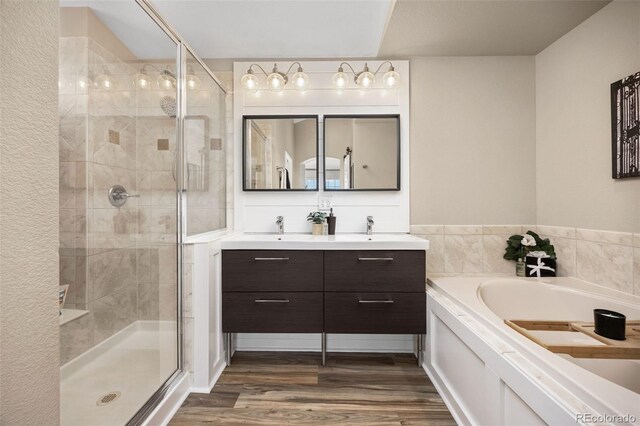 4467 Trailside Ln, Castle Rock, CO 80109 - full bath featuring a garden tub, a shower stall, double vanity, and wood finished floors