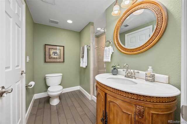 4467 Trailside Ln, Castle Rock, CO 80109 - bathroom featuring toilet, a shower stall, vanity, wood finished floors, and baseboards
