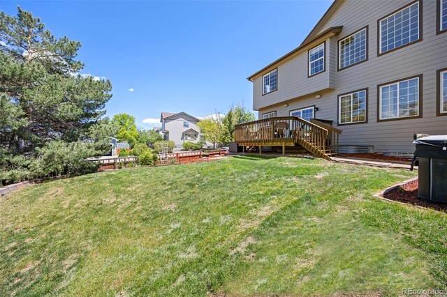4467 Trailside Ln, Castle Rock, CO 80109 - view of green lawn with a wooden deck and stairs