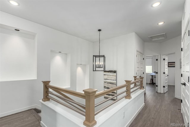 corridor featuring recessed lighting, dark wood-style floors, baseboards, and an upstairs landing