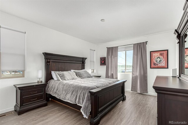 bedroom with light wood-style floors and baseboards