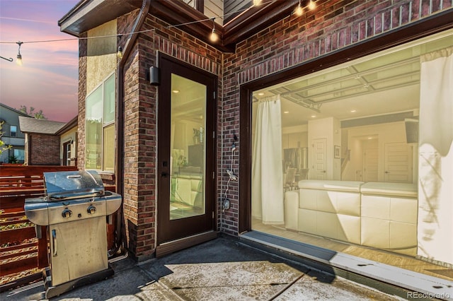 view of exterior entry featuring brick siding