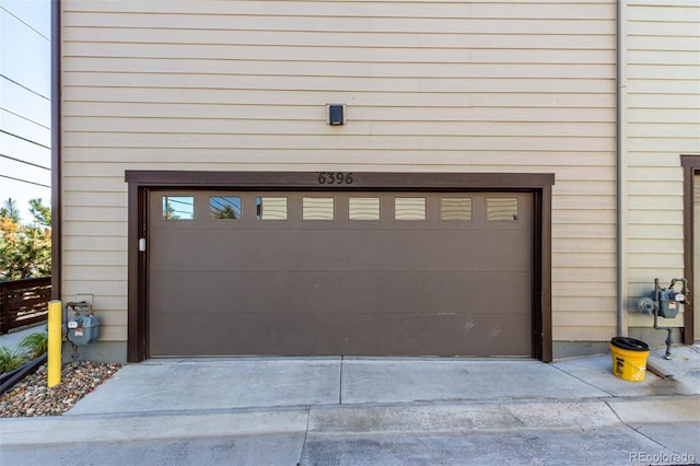 garage featuring concrete driveway