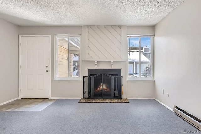 unfurnished living room featuring carpet, baseboard heating, and a textured ceiling