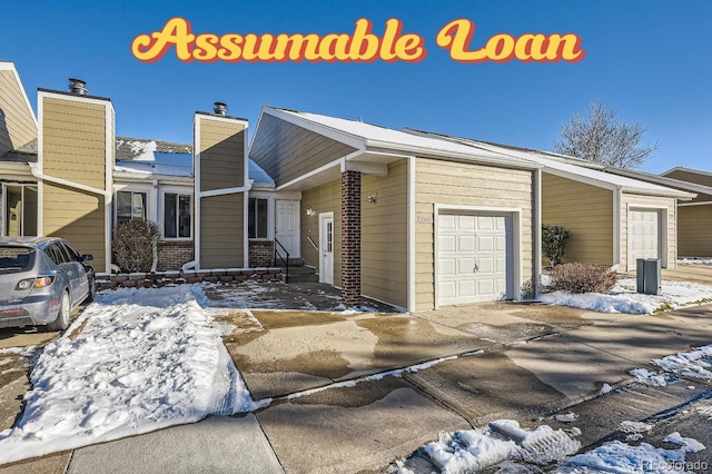 view of front of home with concrete driveway and an attached garage