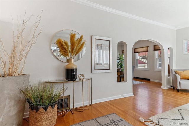 interior space featuring wood-type flooring and crown molding