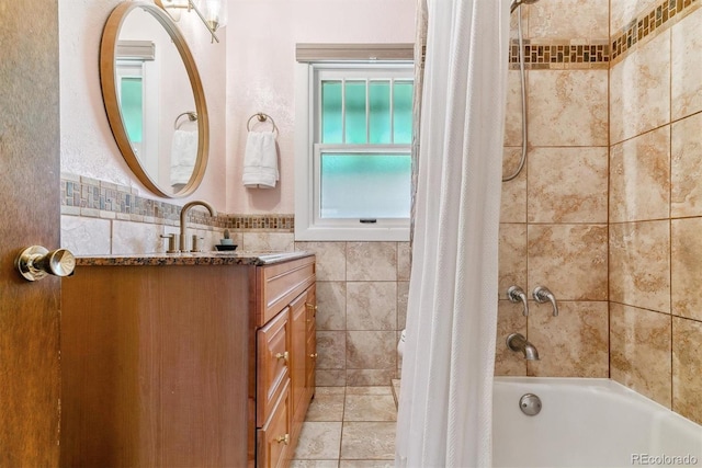 bathroom with shower / bath combo with shower curtain, tile walls, and vanity