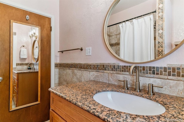 bathroom with tasteful backsplash, vanity, and a shower with curtain