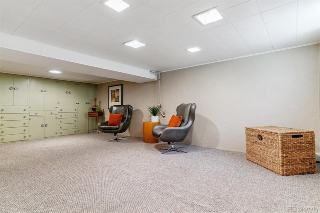 living area featuring carpet and ornamental molding