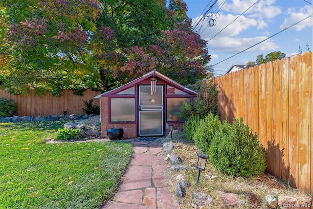 view of outdoor structure featuring a lawn