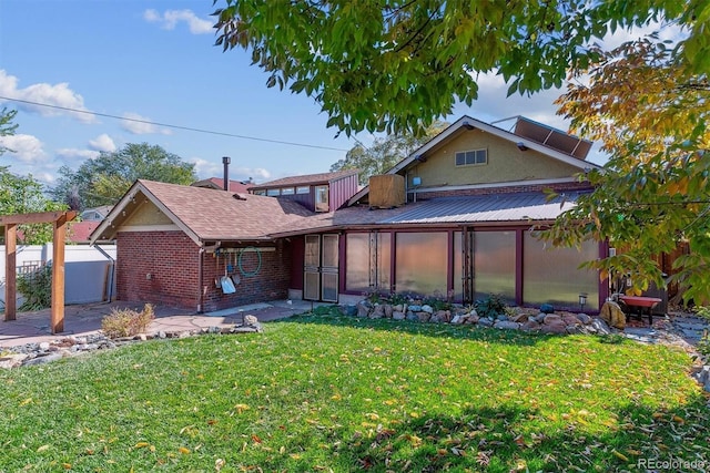 view of front facade featuring a front yard and a patio