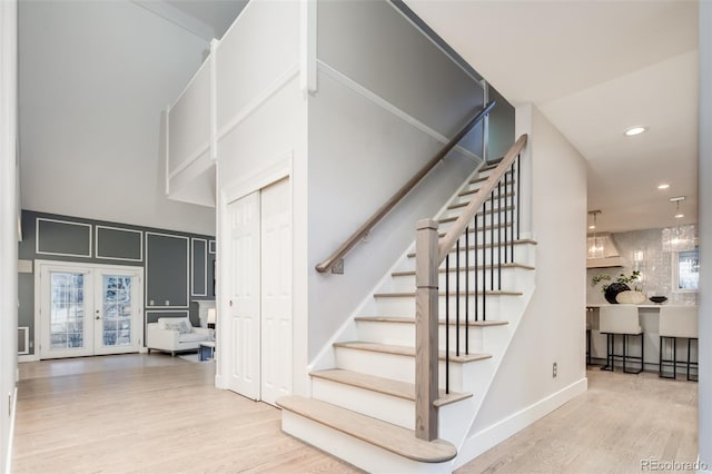 stairway featuring recessed lighting, baseboards, wood finished floors, and french doors