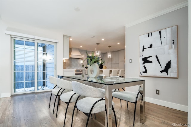 dining area with ornamental molding, recessed lighting, wood finished floors, and baseboards