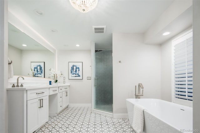 bathroom featuring a stall shower, visible vents, recessed lighting, and double vanity