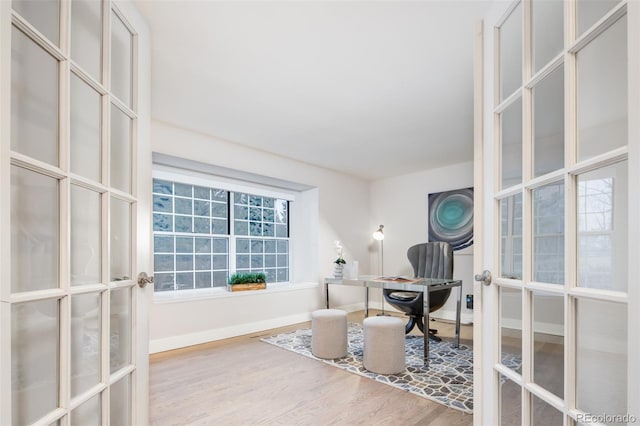 interior space featuring french doors, baseboards, and wood finished floors