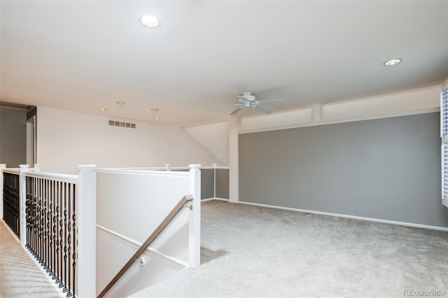 corridor featuring visible vents, carpet, an upstairs landing, and recessed lighting