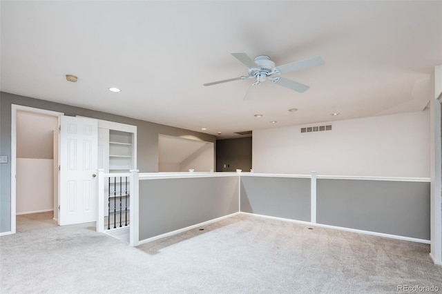 carpeted empty room with recessed lighting, visible vents, and baseboards