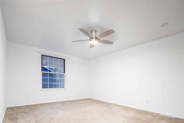 carpeted empty room featuring ceiling fan