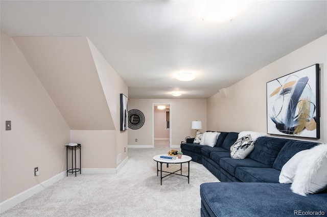 carpeted living area with baseboards