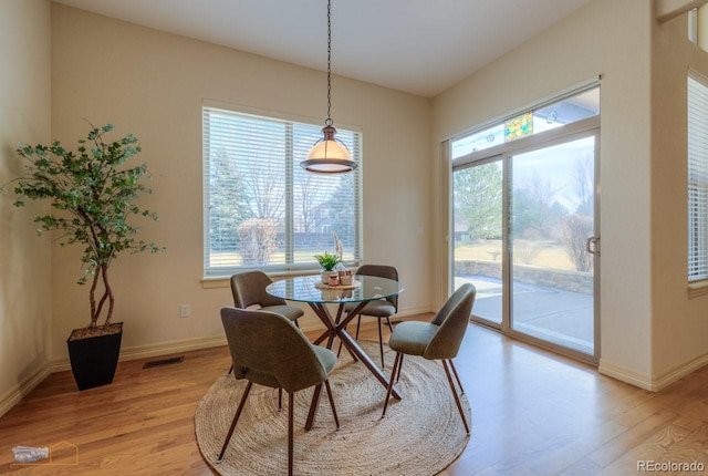 dining space with light hardwood / wood-style flooring