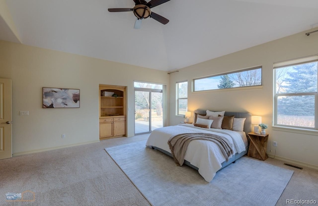 bedroom with multiple windows, light carpet, and access to exterior