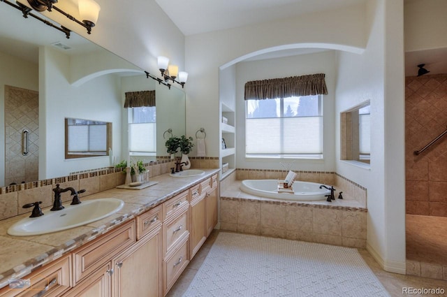 bathroom featuring vanity, tile patterned floors, shower with separate bathtub, and a chandelier