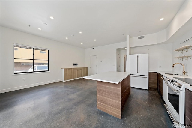 kitchen with sink, a center island, and white appliances