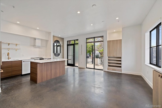 kitchen featuring dishwasher, a center island, and plenty of natural light