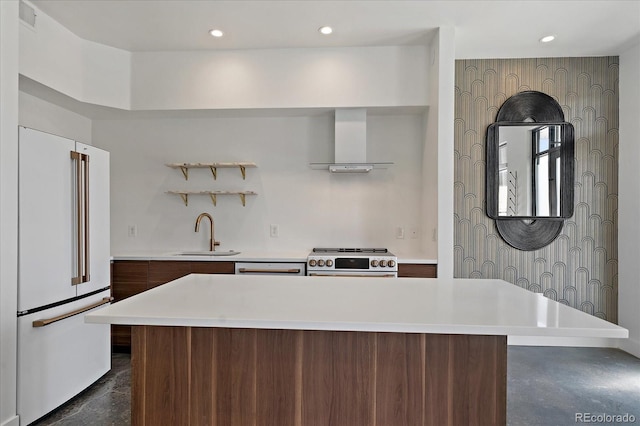 kitchen with sink, a center island, wall chimney range hood, high end white refrigerator, and range