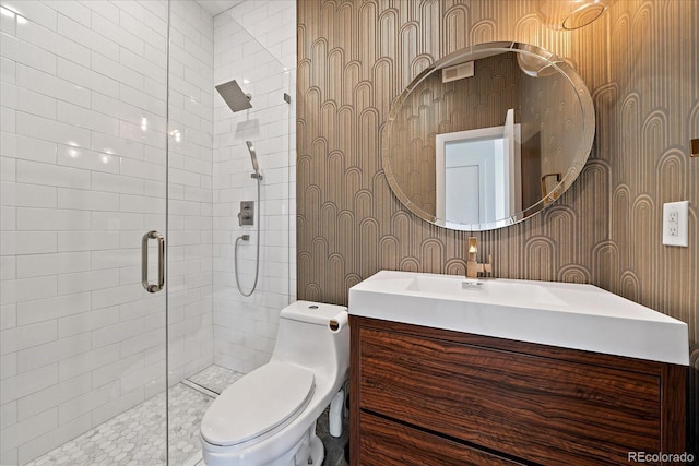 bathroom with vanity, toilet, and a shower with shower door