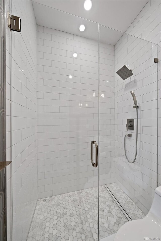 bathroom featuring a shower with door