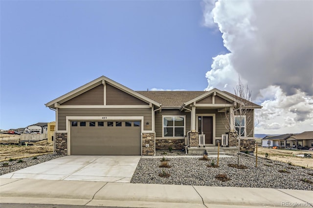 craftsman-style home featuring driveway, a garage, and stone siding