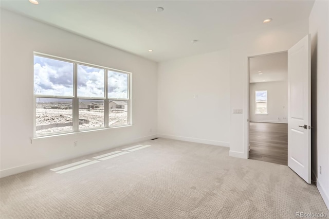 unfurnished room with carpet, baseboards, and recessed lighting