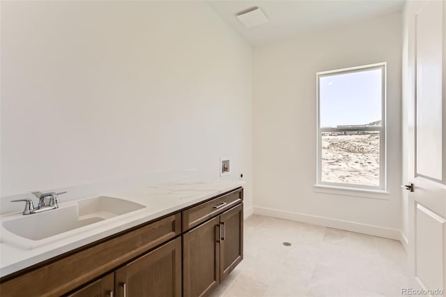 bathroom featuring baseboards and vanity