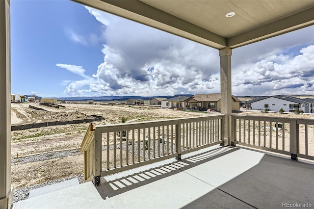view of patio with a residential view and a balcony