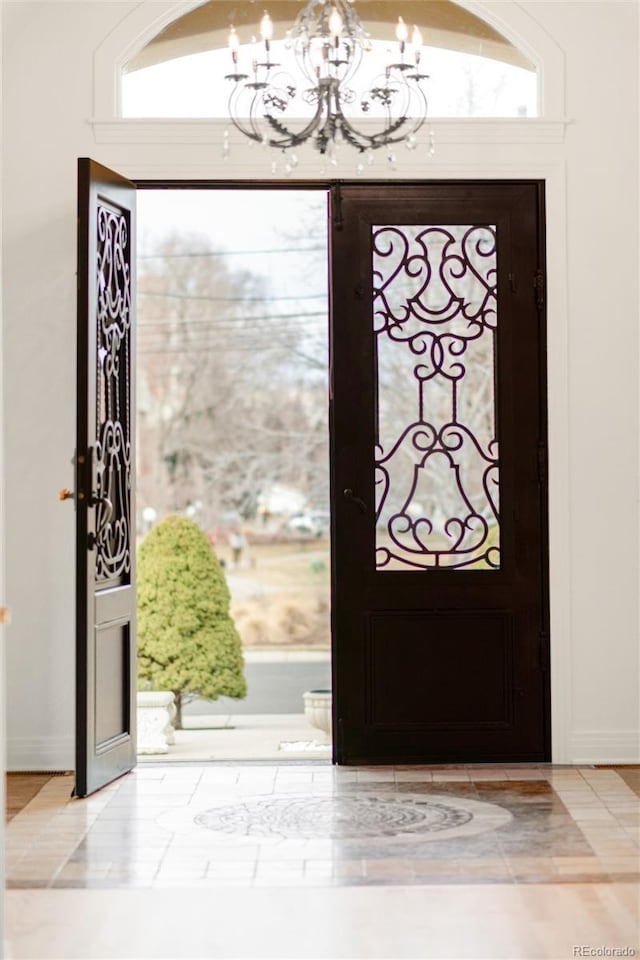 entrance foyer with a chandelier