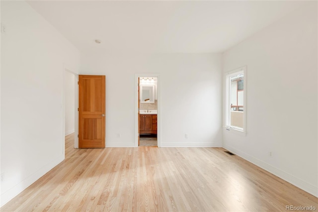 unfurnished bedroom with light wood-style flooring, baseboards, and visible vents