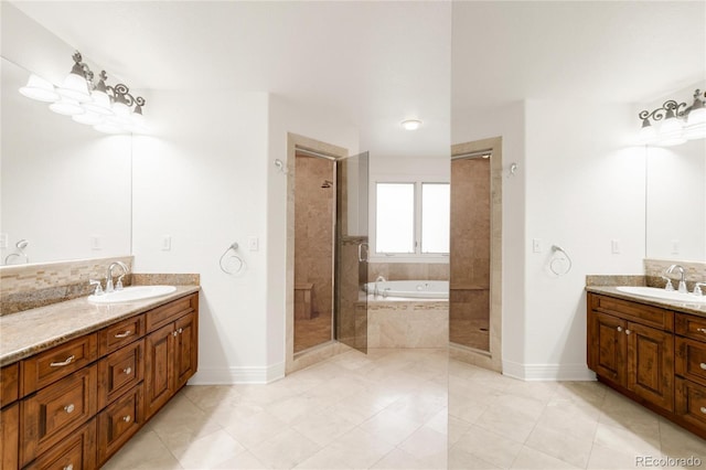 bathroom with a sink, tiled shower, two vanities, and a bath