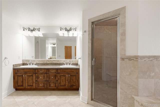 full bath with double vanity, tile patterned floors, a stall shower, and a sink